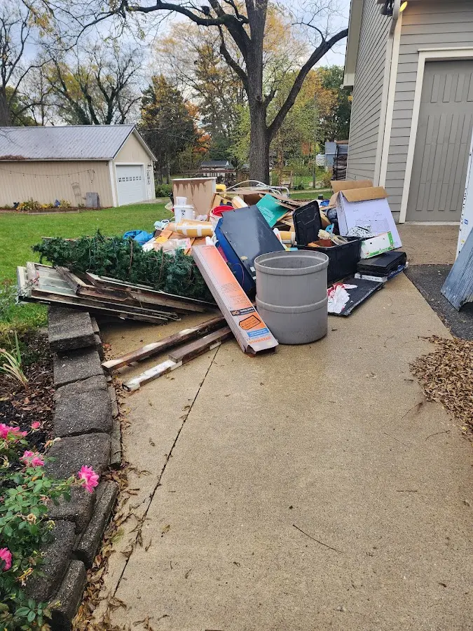 Dumpster being loaded with debris for Estate Cleanout Dumpster Rental in Winter Springs